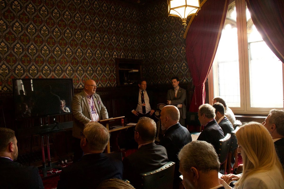 A speaker addressing a small group of business delegates