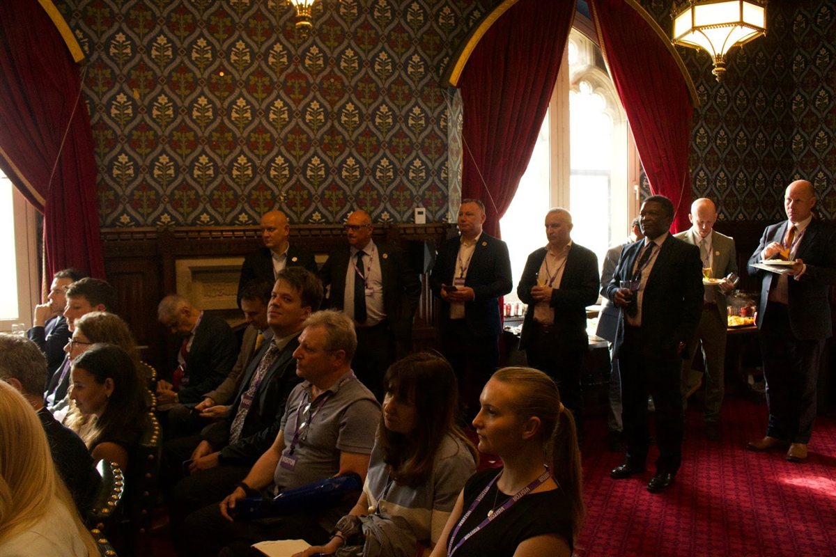 Delegates listening and exchanging ideas at a Westminster event